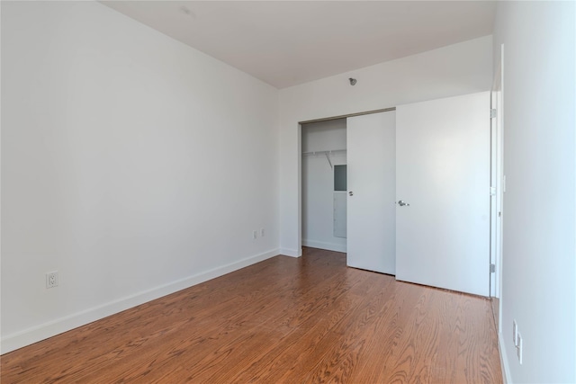 unfurnished bedroom featuring hardwood / wood-style flooring and a closet