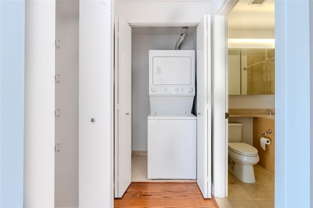 washroom with stacked washer and dryer