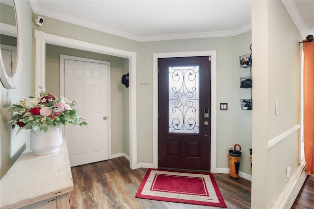 entryway featuring dark wood-style floors, ornamental molding, and baseboards