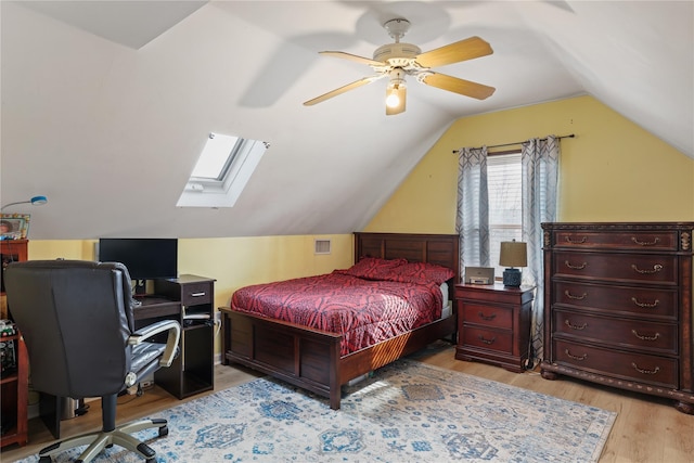 bedroom featuring vaulted ceiling, ceiling fan, visible vents, and light wood-style floors