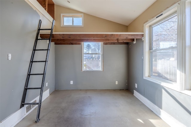 unfurnished room featuring vaulted ceiling and a healthy amount of sunlight