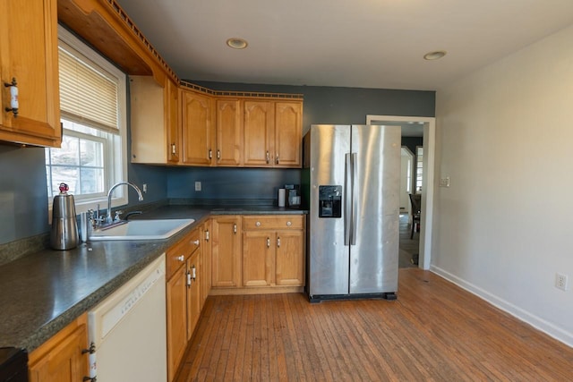 34 Laurel Trl, Monroe, NY 10950 - kitchen featuring stainless steel fridge with ice dispenser, dark countertops, white dishwasher, a sink, and wood finished floors
