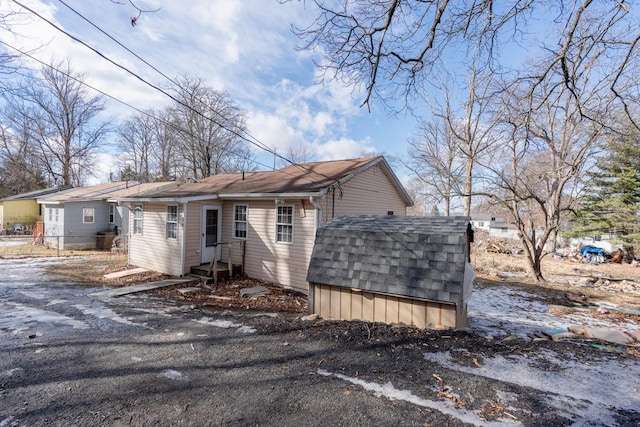 34 Laurel Trl, Monroe, NY 10950 - view of front of property featuring a shed, a shingled roof, entry steps, and an outbuilding