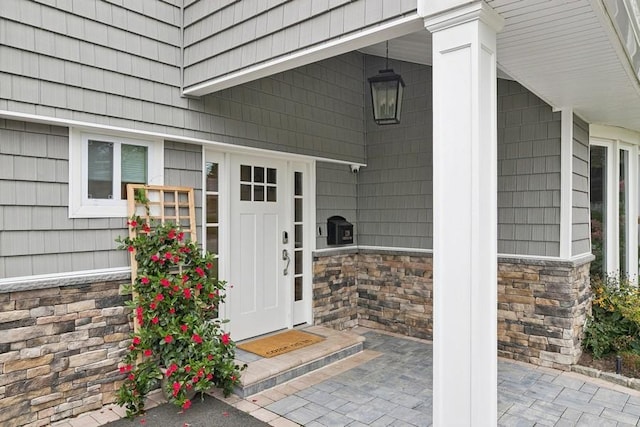 view of exterior entry featuring stone siding