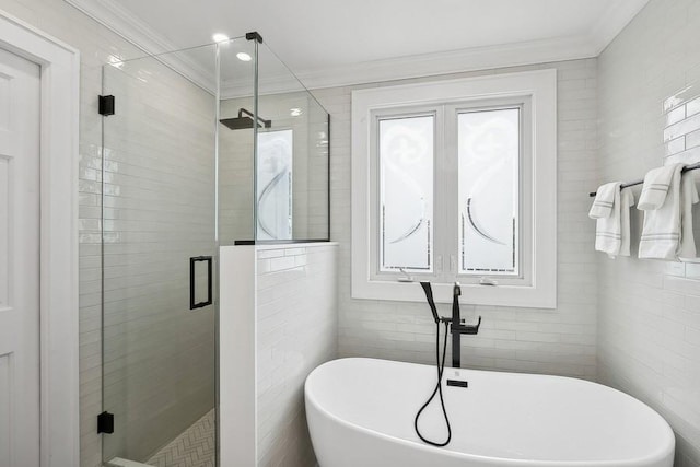 bathroom featuring ornamental molding, a stall shower, a soaking tub, and tile walls