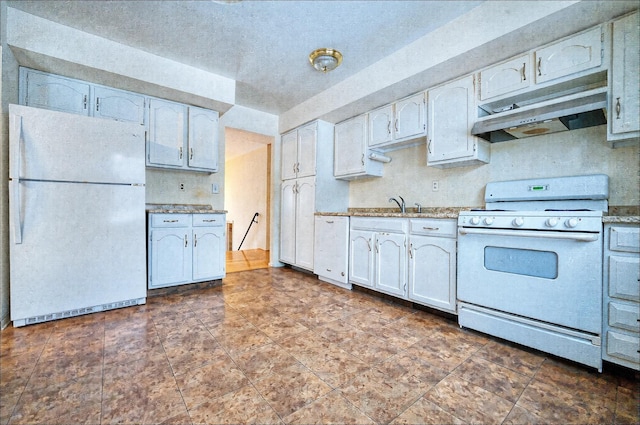 kitchen featuring white appliances, sink, and white cabinets