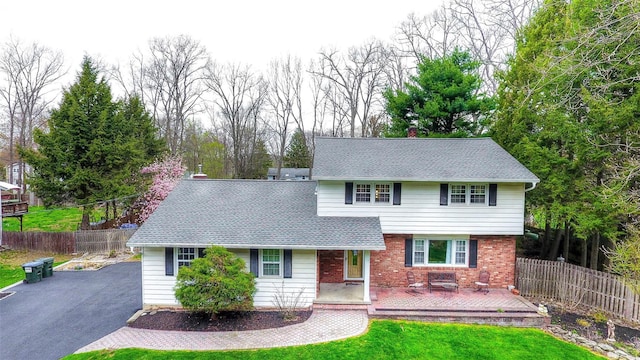 8 Lucky Ln, Washingtonville, NY 10992 - view of front of house featuring roof with shingles, brick siding, asphalt driveway, and a chimney