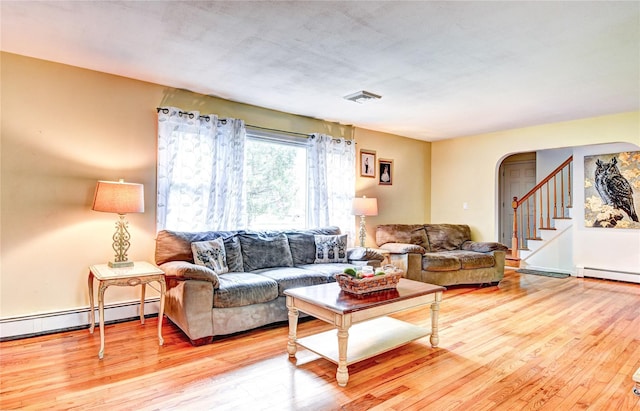 8 Lucky Ln, Washingtonville, NY 10992 - living room with arched walkways, wood finished floors, baseboard heating, and stairs