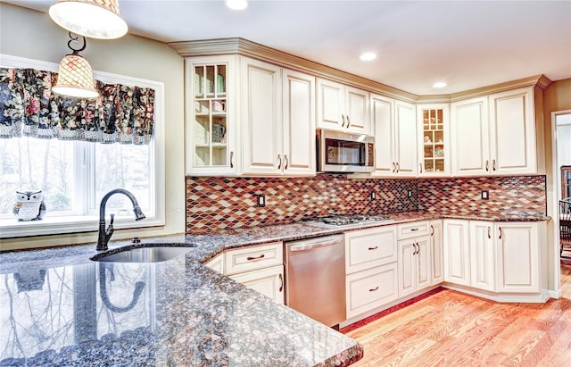8 Lucky Ln, Washingtonville, NY 10992 - kitchen featuring appliances with stainless steel finishes, a sink, light wood-style flooring, dark stone countertops, and glass insert cabinets