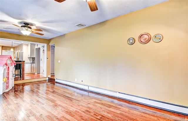 8 Lucky Ln, Washingtonville, NY 10992 - unfurnished living room with ceiling fan, baseboard heating, light wood finished floors, and baseboards