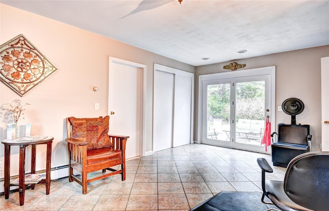 8 Lucky Ln, Washingtonville, NY 10992 - living area with a wood stove, a baseboard radiator, light tile patterned floors, and baseboards