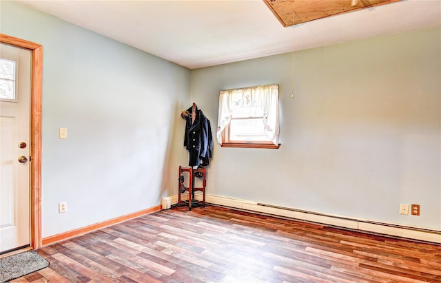 8 Lucky Ln, Washingtonville, NY 10992 - empty room with wood finished floors, healthy amount of natural light, attic access, and a baseboard radiator