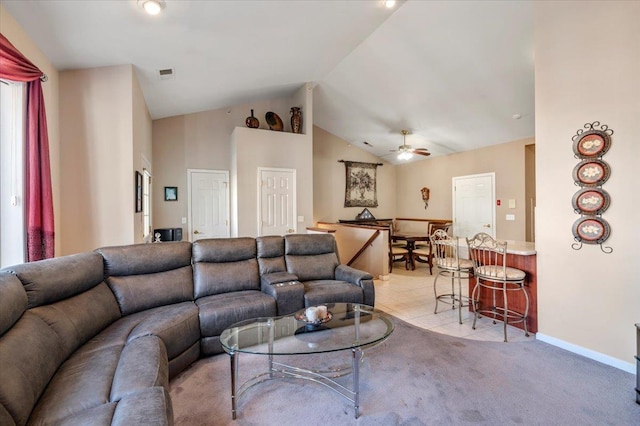 living room with visible vents, baseboards, light colored carpet, ceiling fan, and high vaulted ceiling