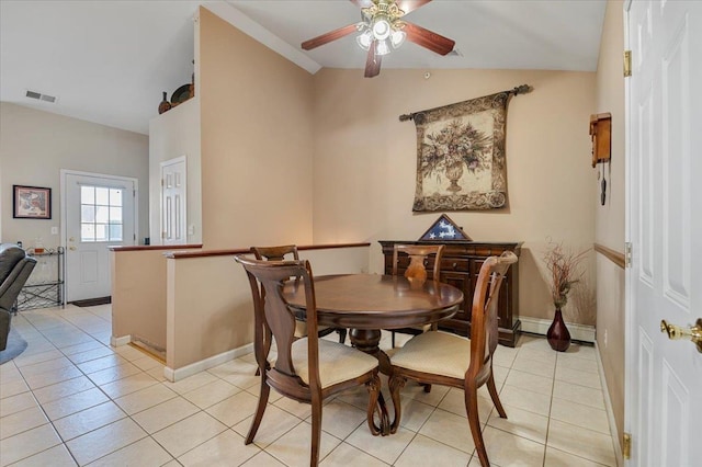 dining space featuring light tile patterned floors, baseboards, visible vents, a ceiling fan, and vaulted ceiling