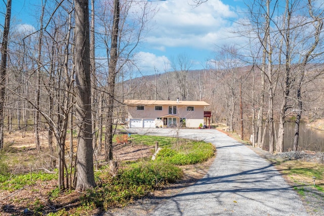 810 Haverstraw Rd, Suffern, NY 10901 - view of front of home with driveway, stucco siding, and a mountain view