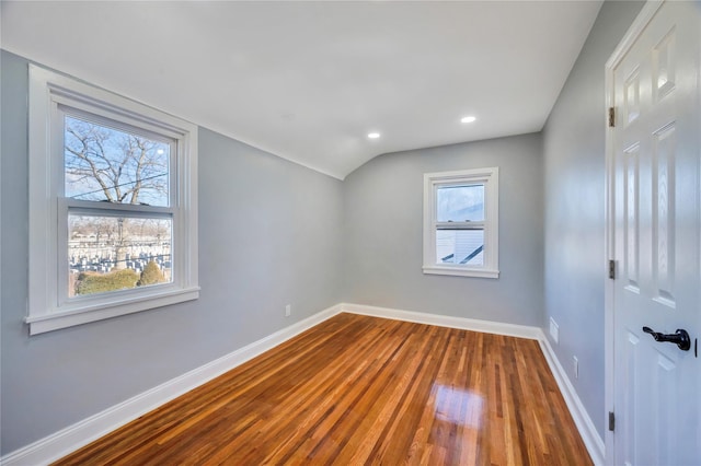 unfurnished room featuring dark wood-type flooring and vaulted ceiling