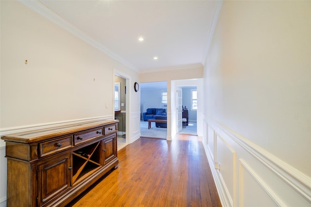 hallway with crown molding and wood-type flooring