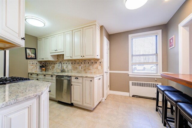 15 Bryant Cres Unit 1K, White Plains, NY 10605 - kitchen featuring decorative backsplash, stainless steel appliances, radiator, and light stone counters