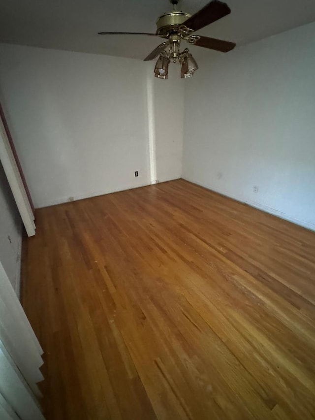 empty room featuring a ceiling fan and wood finished floors