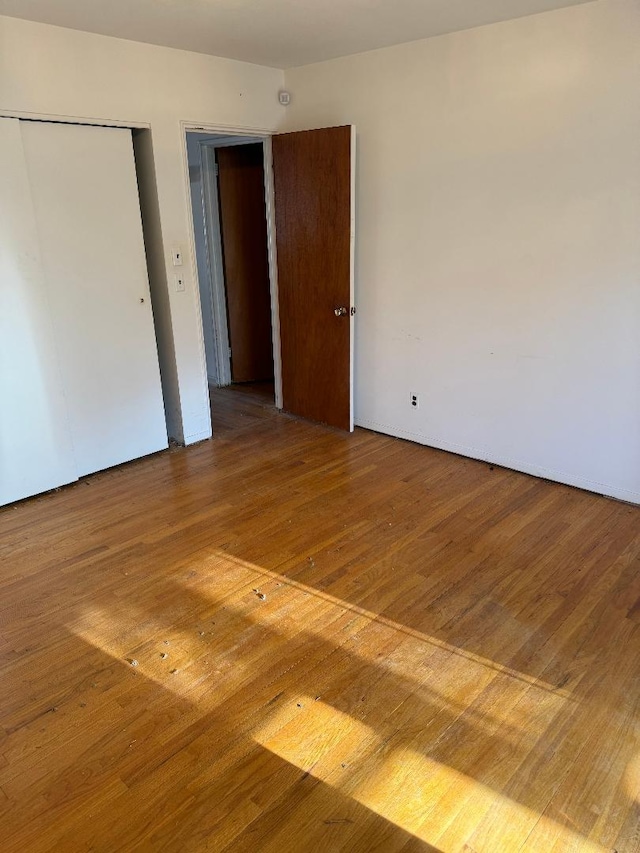 158-24 81st St, Howard Beach, NY 11414 - unfurnished bedroom featuring wood finished floors and a closet