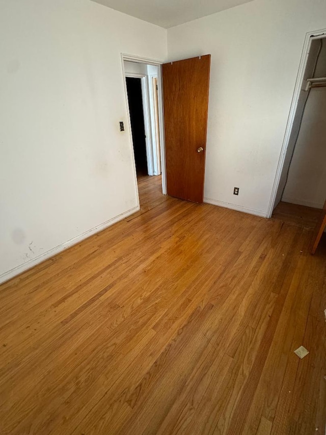 158-24 81st St, Howard Beach, NY 11414 - unfurnished bedroom with light wood-style floors, a closet, and baseboards