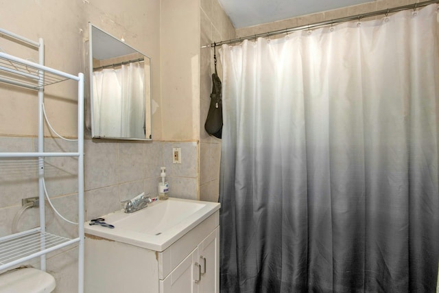 full bath with a shower with shower curtain, decorative backsplash, tile walls, and vanity