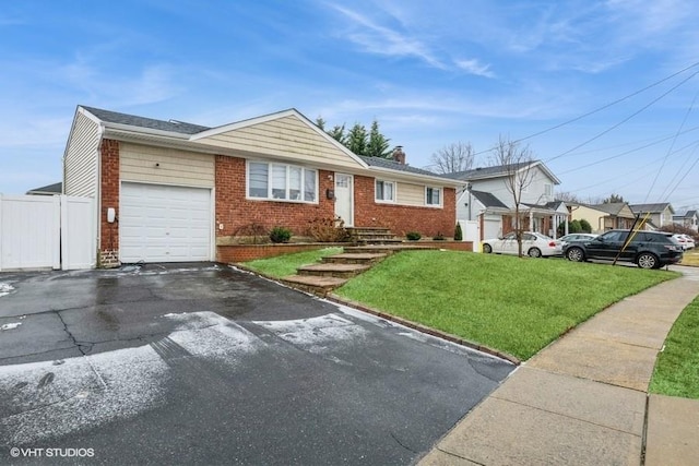 view of front of property featuring a garage and a front yard