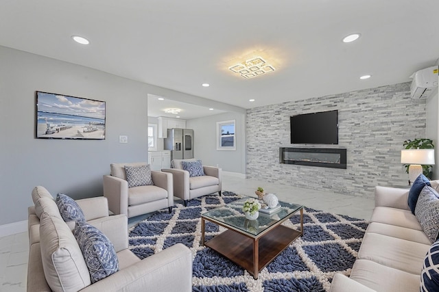 living room featuring a wall unit AC and a large fireplace