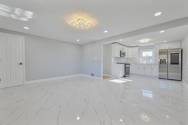 unfurnished living room featuring sink