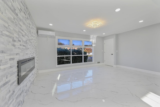 unfurnished living room with heating unit, a fireplace, and a wall mounted AC