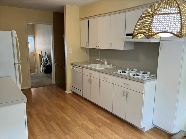 kitchen featuring sink, custom exhaust hood, light hardwood / wood-style flooring, white appliances, and white cabinets