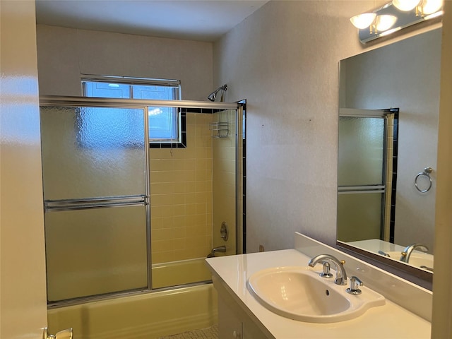 bathroom with vanity and bath / shower combo with glass door