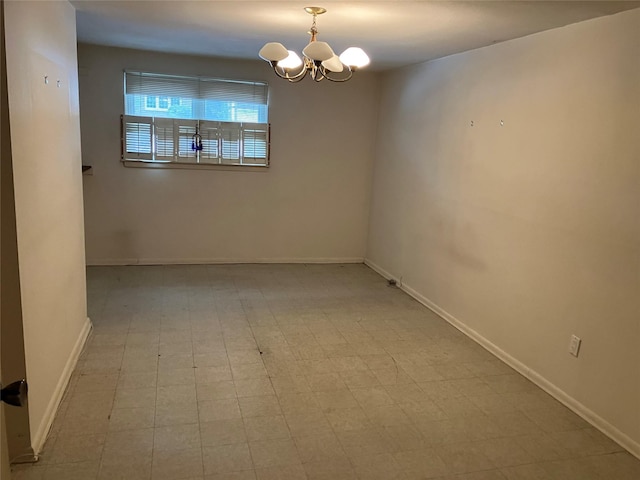 unfurnished room with an inviting chandelier