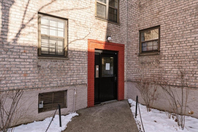 view of snow covered property entrance