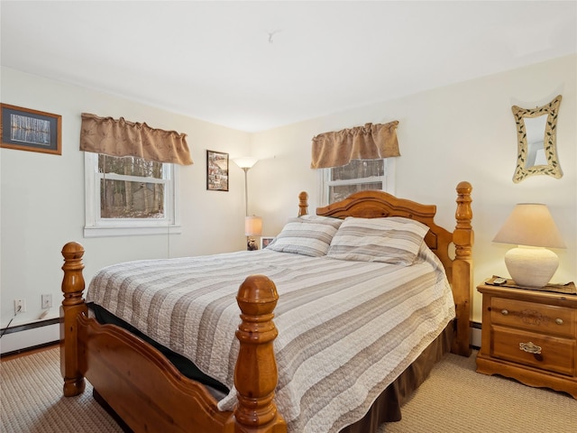 bedroom with a baseboard radiator and light colored carpet