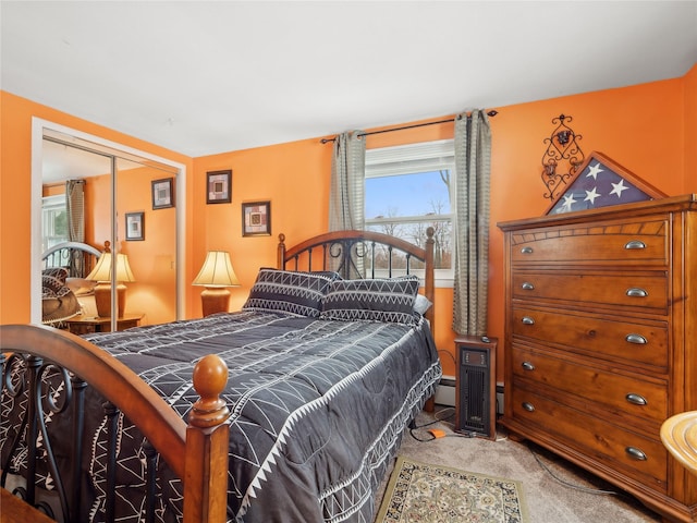 carpeted bedroom with a baseboard radiator and a closet