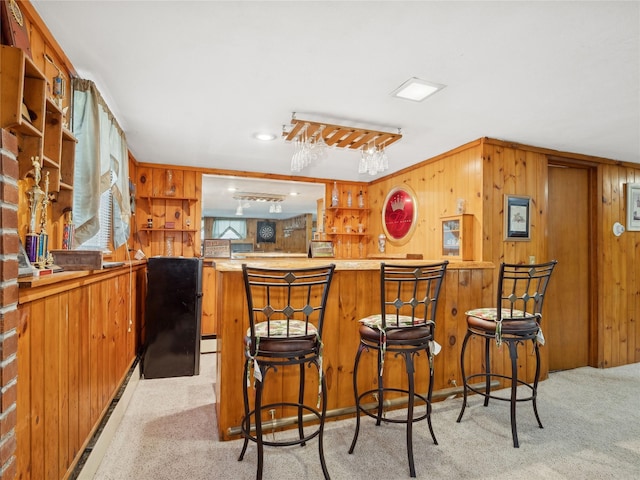 bar featuring light colored carpet and wood walls