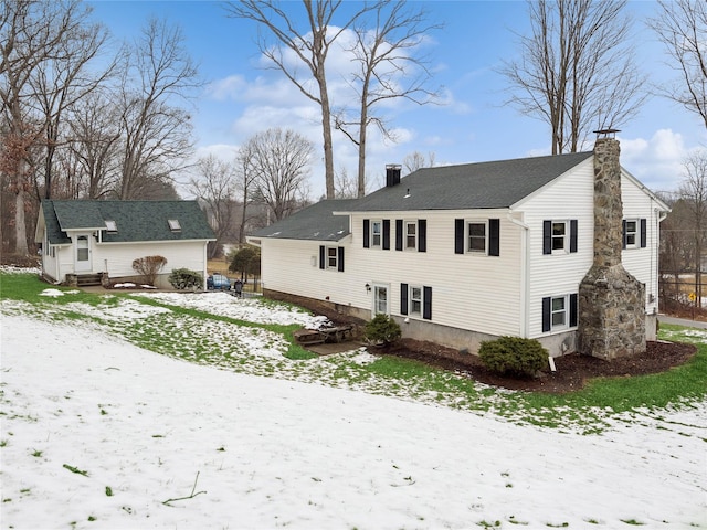 view of snow covered back of property