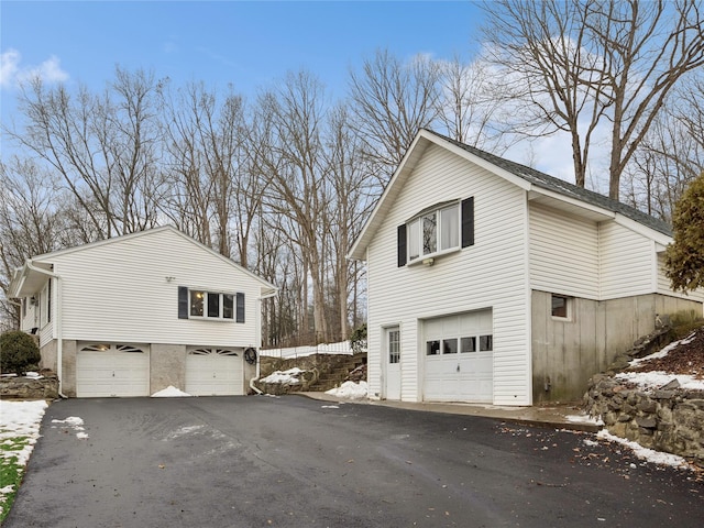 view of snow covered exterior featuring a garage