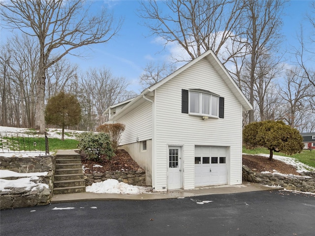 view of snow covered exterior featuring a garage