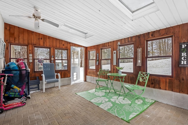 sunroom featuring ceiling fan and lofted ceiling