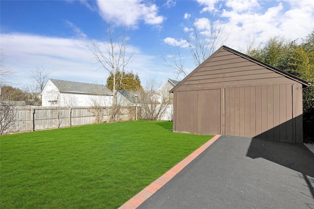 view of yard with an outbuilding, a pole building, and fence