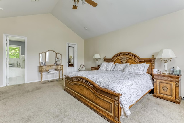 bedroom featuring a ceiling fan, light carpet, connected bathroom, high vaulted ceiling, and baseboards