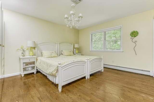 bedroom featuring visible vents, baseboards, a baseboard radiator, light wood-style floors, and a chandelier