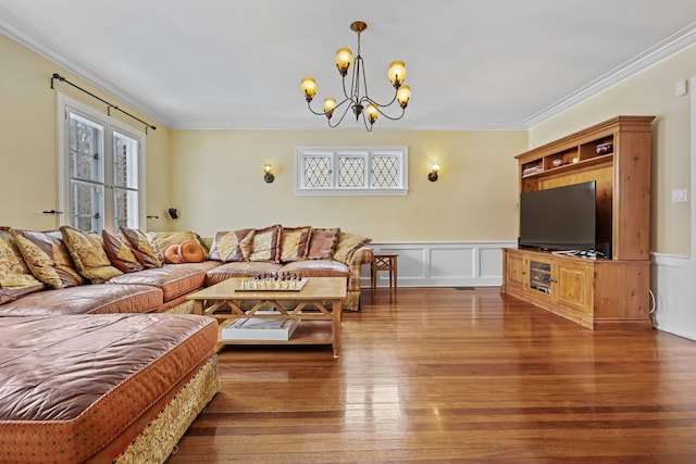 living room with ornamental molding, a chandelier, and dark hardwood / wood-style floors