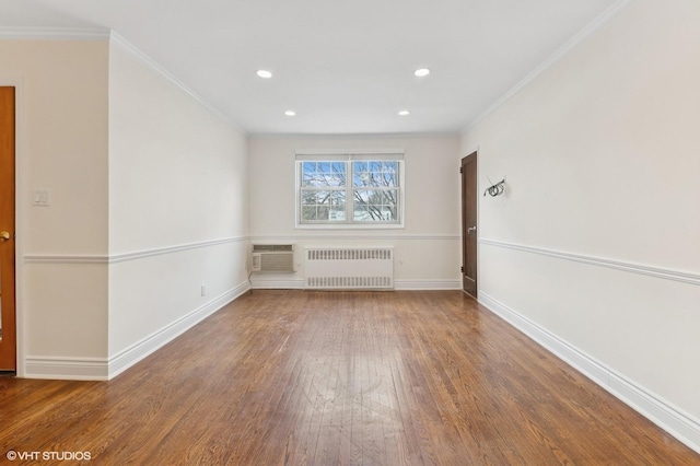 unfurnished room with crown molding, radiator, hardwood / wood-style flooring, and a wall unit AC