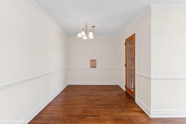 empty room with ornamental molding, a chandelier, and dark hardwood / wood-style flooring