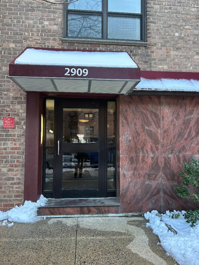 view of snow covered property entrance