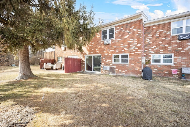 rear view of house featuring brick siding