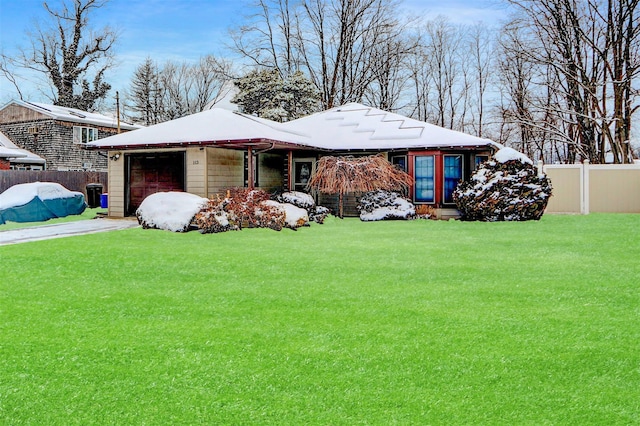 view of front of house featuring a garage and a front lawn